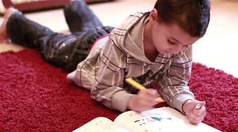Little boy coloring on floor Stock Footage 24665071
