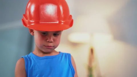 A little boy in construction helmets talking to a father that helping and Stock Footage 131861894