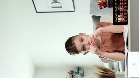 Little boy counting with the help of mental arithmetic. Mathematics in pleasure Stock Footage 236257653