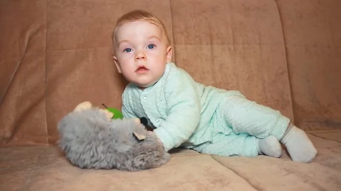 A little boy crawls on the sofa Video stock 123285996
