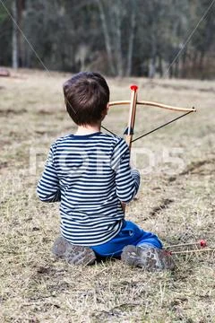 Little boy with a crossbow I Stock Photos