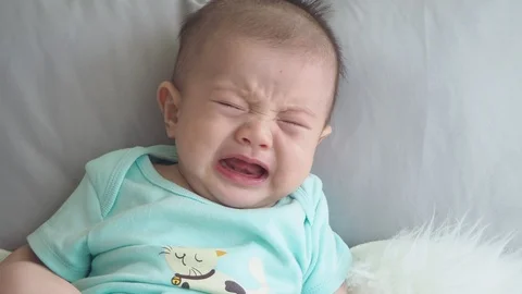 Little boy crying on bed Stock Footage 108646139