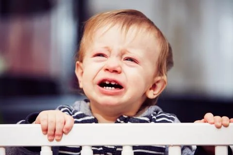 Little boy is crying in the bed Stock Photos