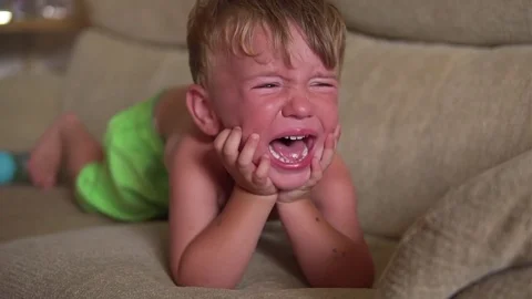 Little Boy Crying  on the sofa In Slow Motion Stock Footage 80238120