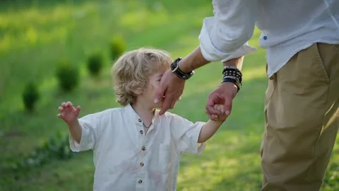 Little boy is crying while holding his father's hand. Concept of parental Stock-Footage 289977631