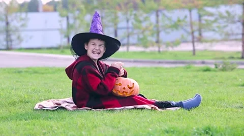 Little boy cuts out pumpkin on a Halloween Stock Footage 68097986