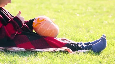 Little boy cuts out pumpkin on a Halloween Stock Footage 68100099