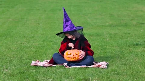 Little boy cuts out pumpkin on a Halloween Stock Footage 68100131
