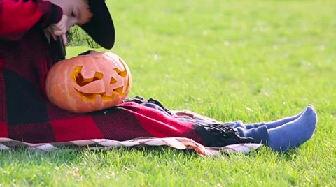 Little boy cuts out pumpkin on a Halloween Stock Footage 68100144