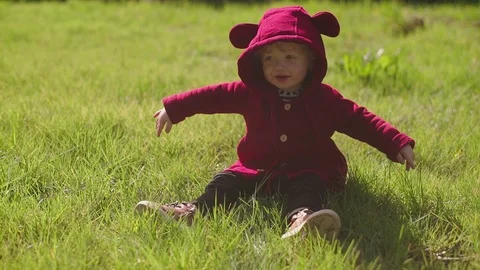 The little boy dance sitting on the grass Stock Footage 87096950