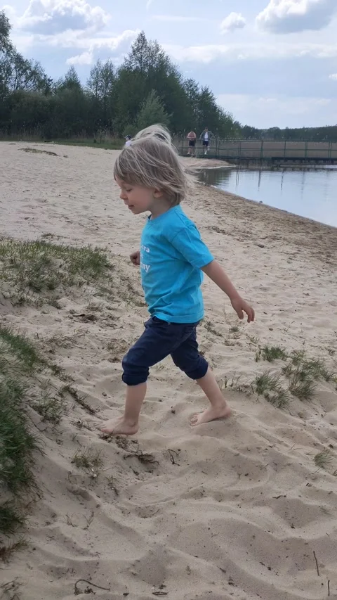 Little boy dancing on the beach. Child boy dansing on the beach. Kid is running Stock Footage 245813426