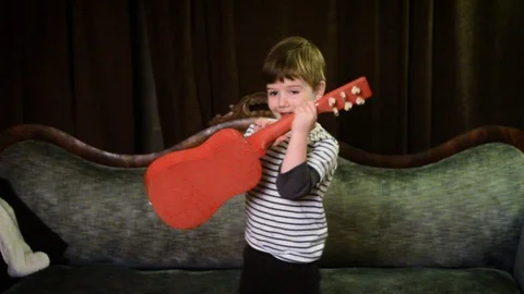 Little Boy Dancing Strumming Ukelele Stock Footage 115819015