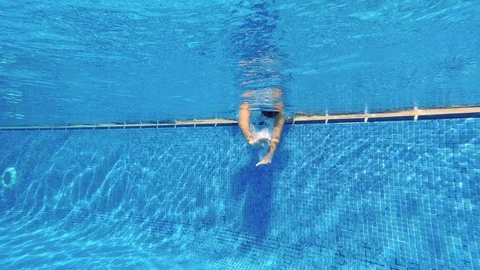 Little boy diving in a pool Stock Footage 119694183
