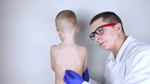 A little boy at the doctor's appointment with back pain. Treatment of spinal def Stock Footage 148488963