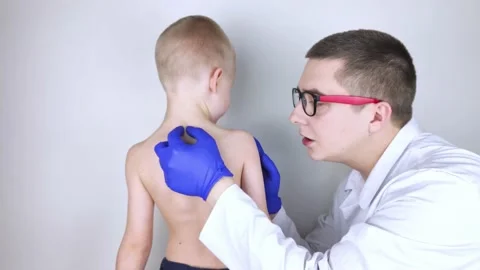 A little boy at the doctor's appointment with back pain. Treatment of spinal def Stock Footage 148488973