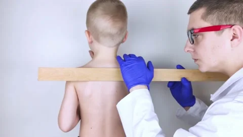 A little boy at the doctor's appointment with back pain. Treatment of spinal def Stock Footage 148488984