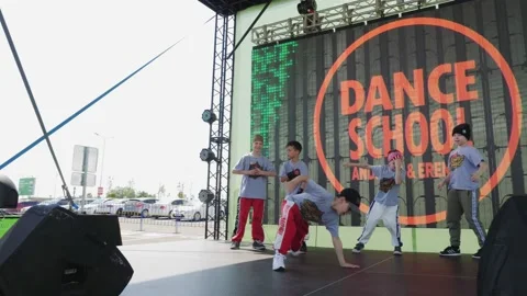 Little boy does break dance elements near friends on stage Stock Footage 135421440