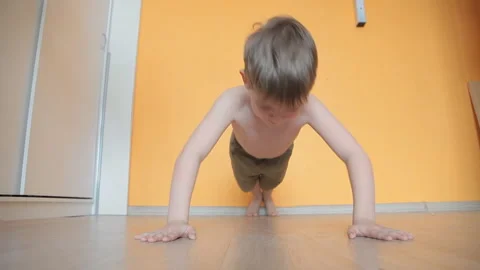 The little boy does exercises, plays sports is in the strap on the hands Stock Footage 106381731