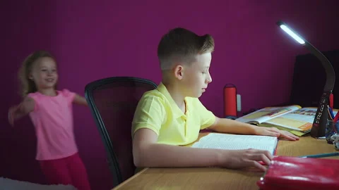A little boy does his homework, writes useful information. Video stock 132036329