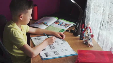 Little boy does homework, writes useful information. Slow Motion. Stock Footage 132033470