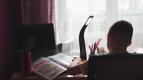 Little boy does homework, writes useful information. Slow Motion. Video stock 132033629