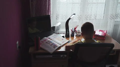Little boy does homework, writes useful information. Slow Motion. Video stock 132033923