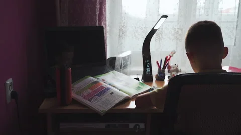 Little boy does homework, writes useful information. Slow Motion. Video stock 132034141