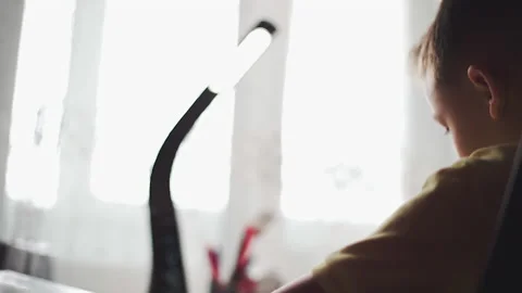 Little boy does homework, writes useful information. Slow Motion. Video stock 132034581