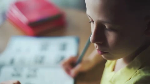 Little boy does homework, writes useful information. Slow Motion. Video stock 132034774