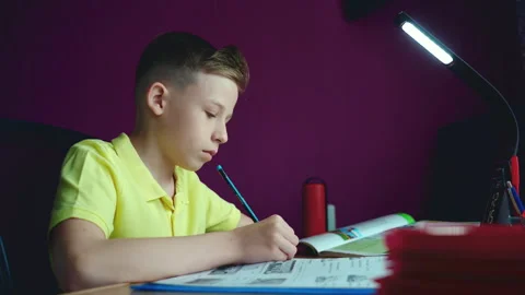 Little boy does homework, writes useful information. Slow Motion. Stock Footage 132056094
