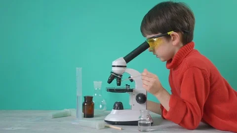 Little boy doing biochemistry research at home Stock Footage 104976449