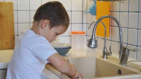 Little boy doing the dishes Stock Footage 115878130