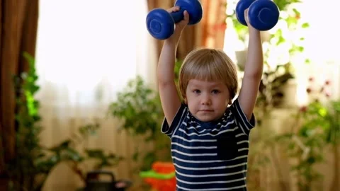 Little Boy Doing Exercises with Dumbbells Vídeo Stock 87948968