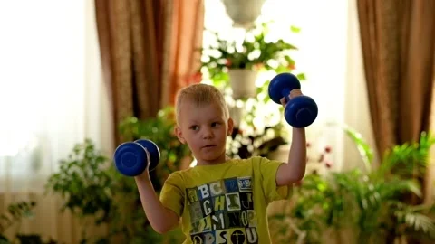 Little Boy Doing Exercises with Dumbbells Stock Footage 87949069