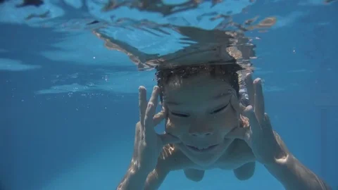 Little Boy doing funny faces, diving &amp; Playing in Swimming Pool 4K Stock-Footage 84065394