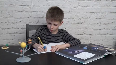 Little boy doing homework Stock Footage 69216992