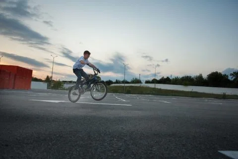 Little boy doing tricks jumping riding bike Stock Photos