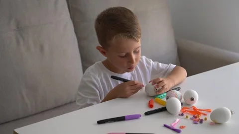 Little Boy Drawing on Easter Egg with Marker at Home 스톡 동영상 330466546