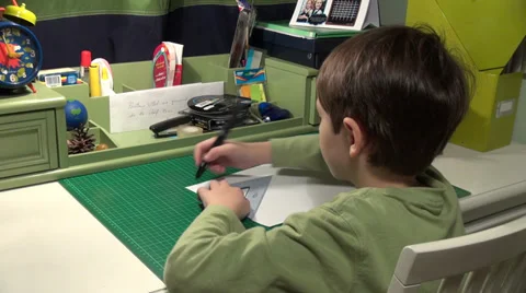 Little boy drawing at math, child works at his desk, school boy doing homework Stock Footage 33916637