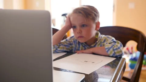 Little Boy Drawing While Using A Laptop Video stock 129499399
