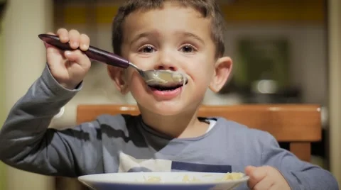 Little boy drinking soup Видео 57842559