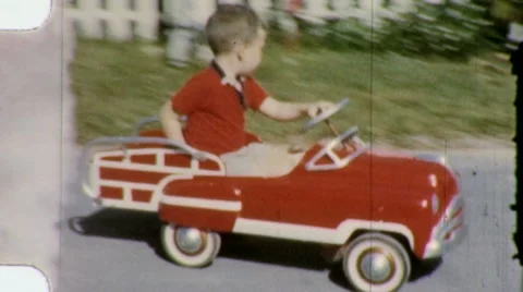 LITTLE BOY DRIVES PEDAL CAR Plays Rides 1960s Vintage Film Home Movie Stock Footage