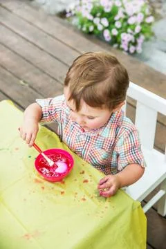 Little Boy Dyes his Easter Egg Pink Stock Photos