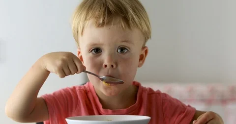 Little boy eating cornflakes for breakfast Stock Footage 101823484