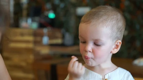 The little boy eats at a cafe Stock Footage 74170370