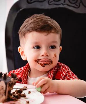 Little boy eats cake and gets dirty Stock Photos