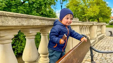A little boy eats a chocolate ice cream candy on a stick. Close-up of a his face Stock-Fotos