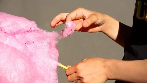 Little boy eats cotton candy at an amusement park. Video stock 117939710