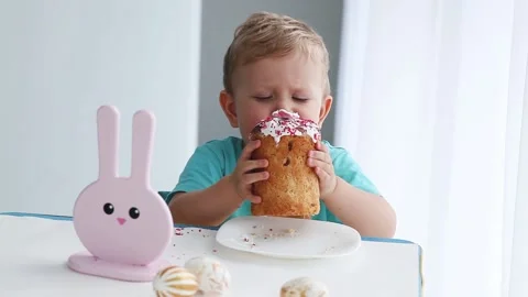 Little boy eats an Easter cake. Stock Footage 142534010
