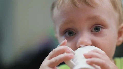 Little boy eats ice cream. Favorite treat. Blue-eyed child happily eats ice Stock Footage 136740441